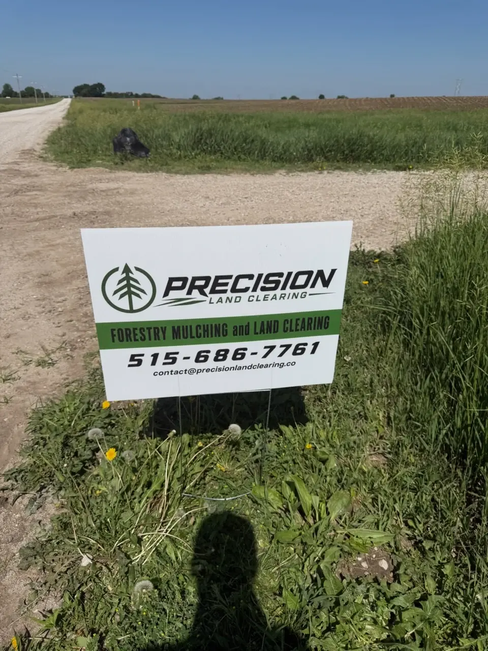 Precision Land Clearing project sign beside an Iowa property