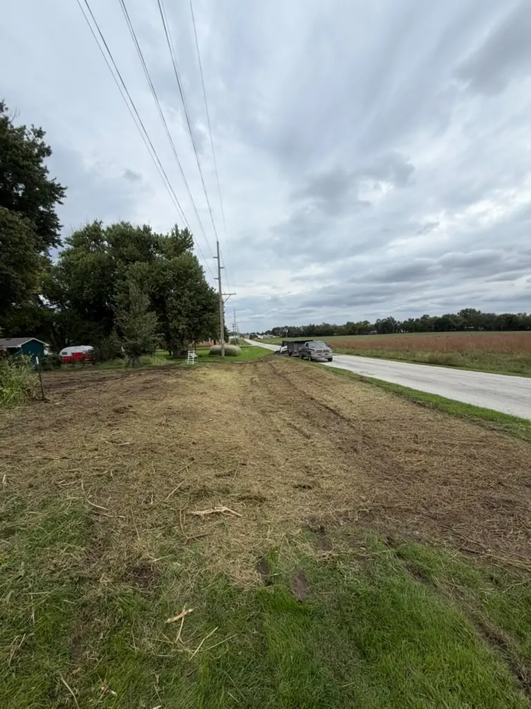 Freshly mown roadside lot and ditch alongside an Iowa farm field