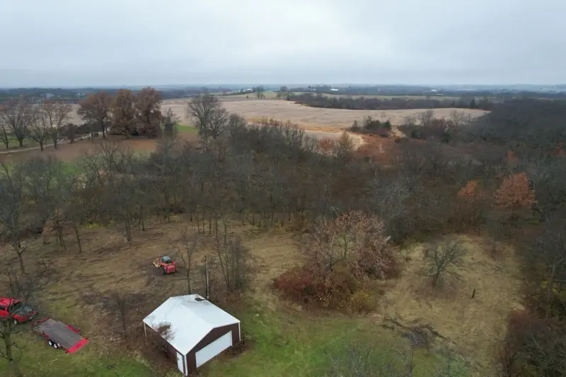 Aerial view of mown acreage surrounding a rural outbuilding