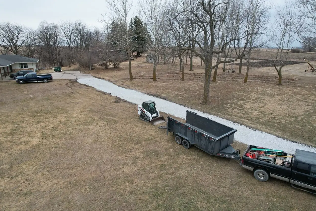 Aerial view of a completed gravel driveway with truck and equipment
